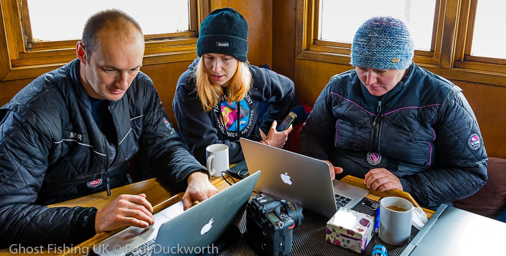 Ghost Fishing UK team members with laptops on the MV Halton dive boat